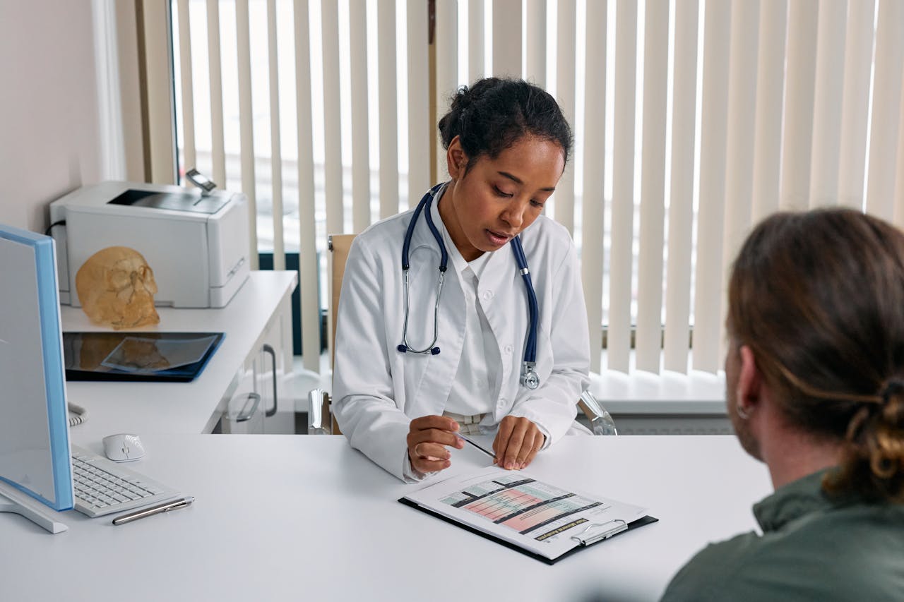 Crafting Captivating Headlines: Your awesome post title goes here A doctor consulting with a patient in an office, discussing a medical chart.